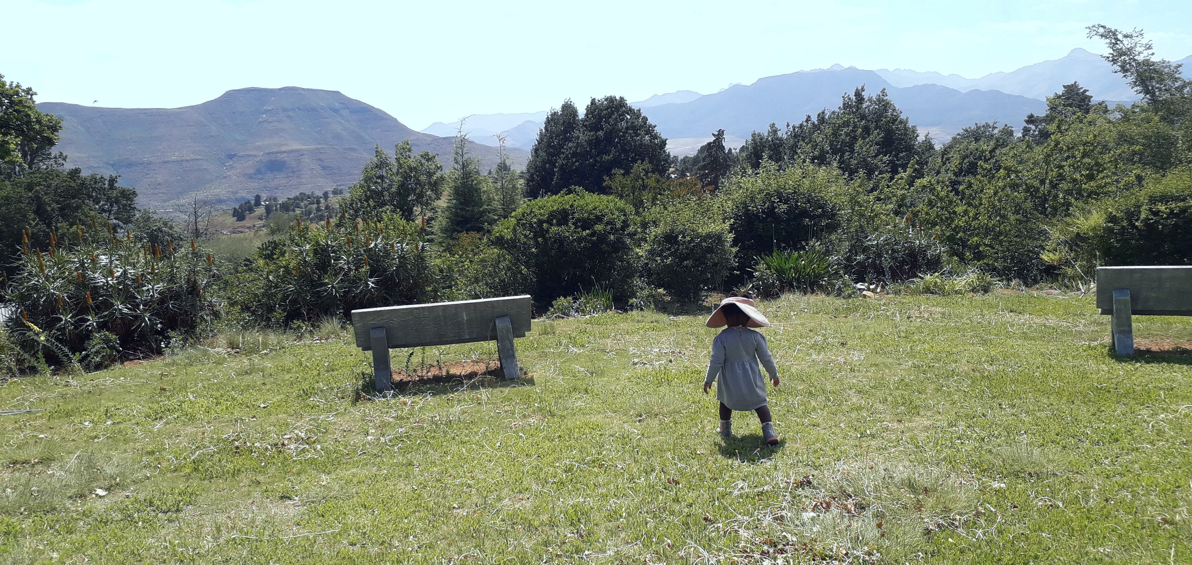 Child walking towards a mountain view
